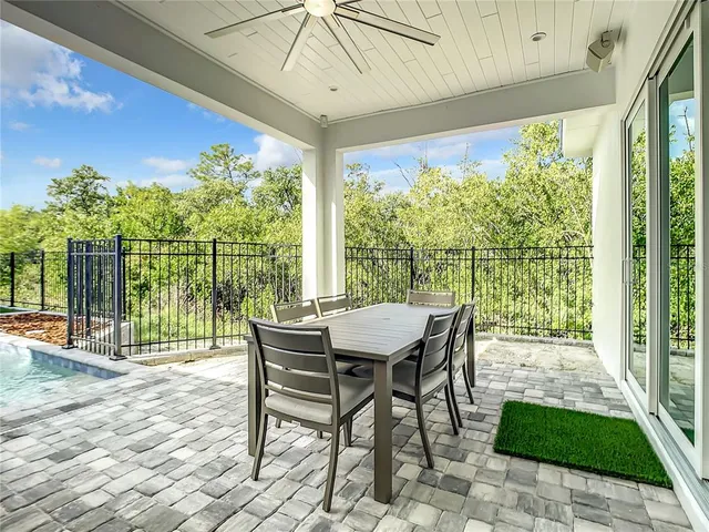 a view of a patio with a table chairs and backyard