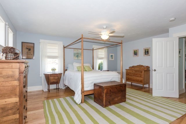 140 Warren Street Upton, MA 01568 - Photo 19 of 37 a bedroom with a bed and wooden floor