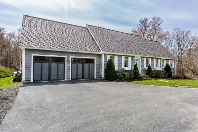 140 Warren Street Upton, MA 01568 - Photo 2 of 37 a front view of a house with a yard and trees