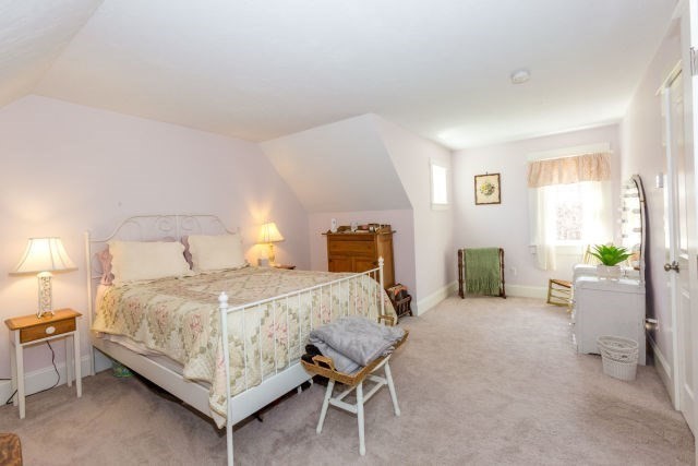140 Warren Street Upton, MA 01568 - Photo 23 of 37 a bedroom with a bed and a chair