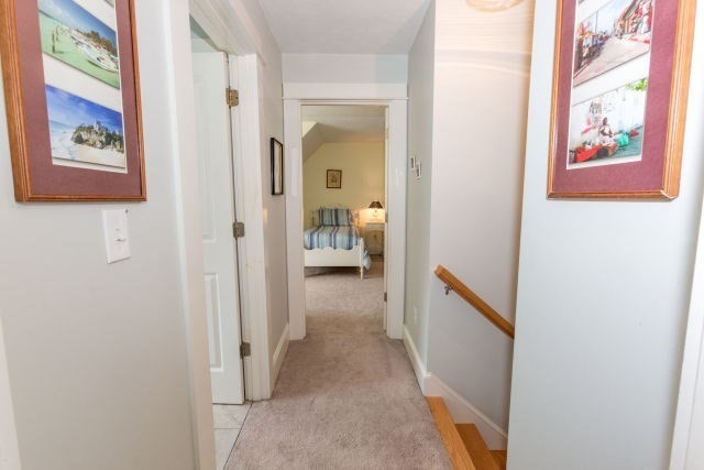 140 Warren Street Upton, MA 01568 - Photo 25 of 37 a view of a hallway with paintings on the wall