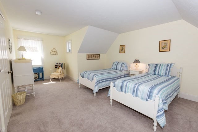 140 Warren Street Upton, MA 01568 - Photo 27 of 37 a bedroom with a bed and chair