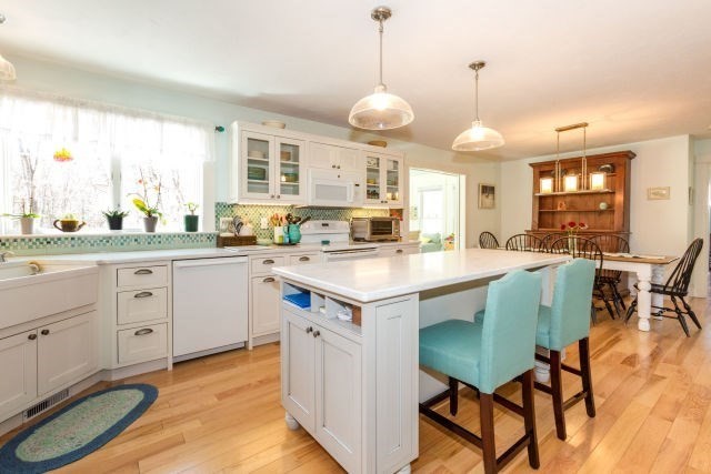 140 Warren Street Upton, MA 01568 - Photo 3 of 37 a kitchen with a dining table chairs sink and cabinets