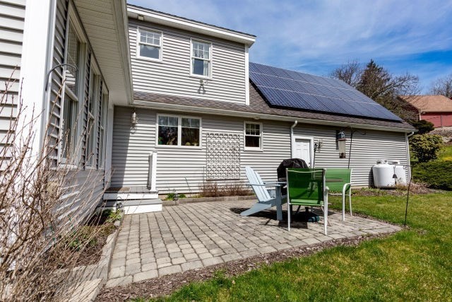 140 Warren Street Upton, MA 01568 - Photo 33 of 37 a view of backyard with table and chairs and wooden fence