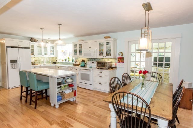 140 Warren Street Upton, MA 01568 - Photo 6 of 37 a view of a dining room and livingroom with furniture wooden floor a chandelier