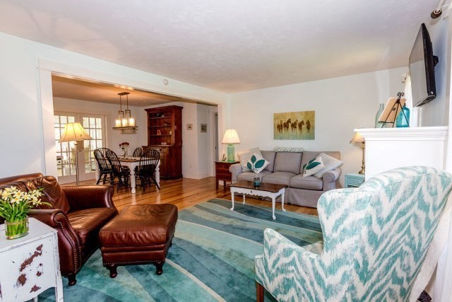140 Warren Street Upton, MA 01568 - Photo 10 of 37 a living room with furniture and a flat screen tv