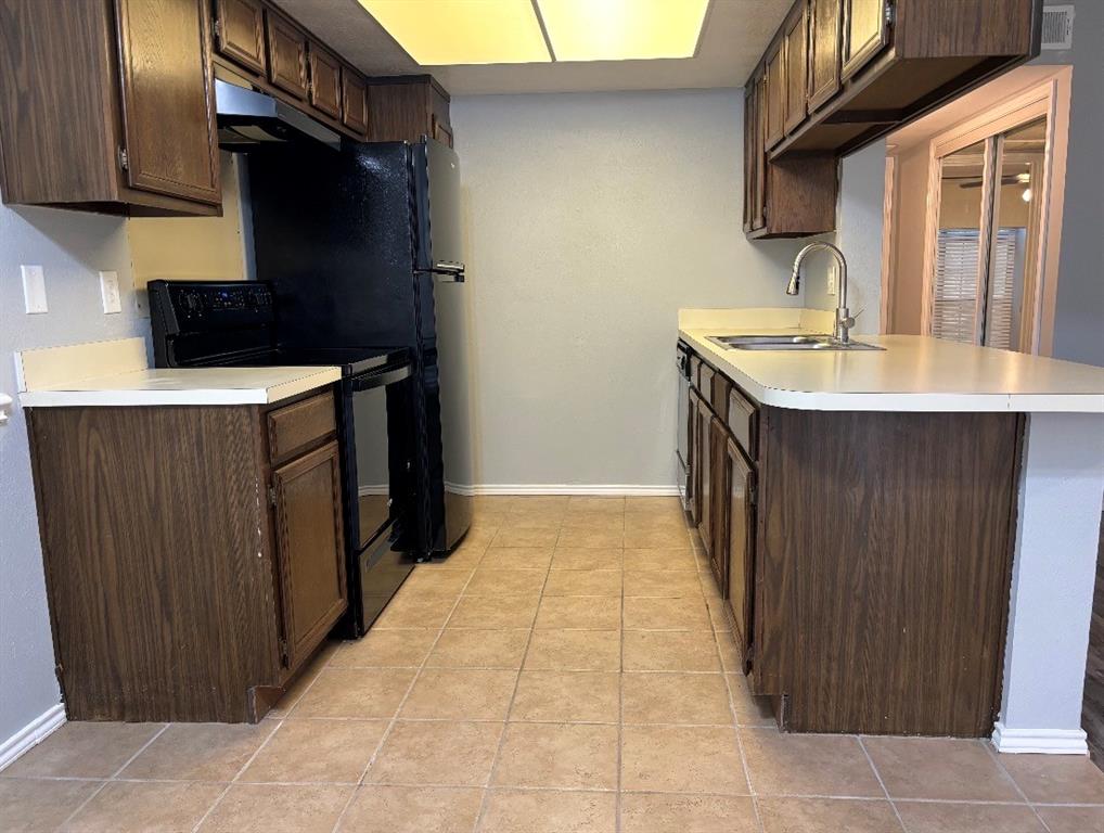 4412 Chaha Road, Unit 106 Garland, TX 75043 - Photo 2 of 4 a kitchen with a sink and cabinets