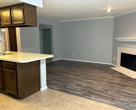 a view of an empty room with window and fireplace