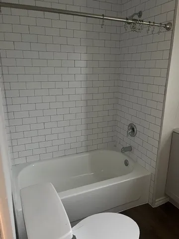 a bathroom with a bathtub and a toilet