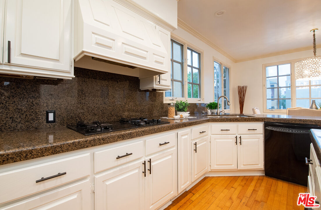 115 Roma Court Marina del Rey, CA 90292 - Photo 20 of 50 a kitchen with granite countertop white cabinets and a sink