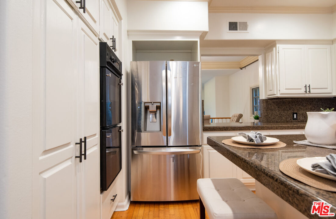 115 Roma Court Marina del Rey, CA 90292 - Photo 22 of 50 a kitchen with a refrigerator and a stove top oven