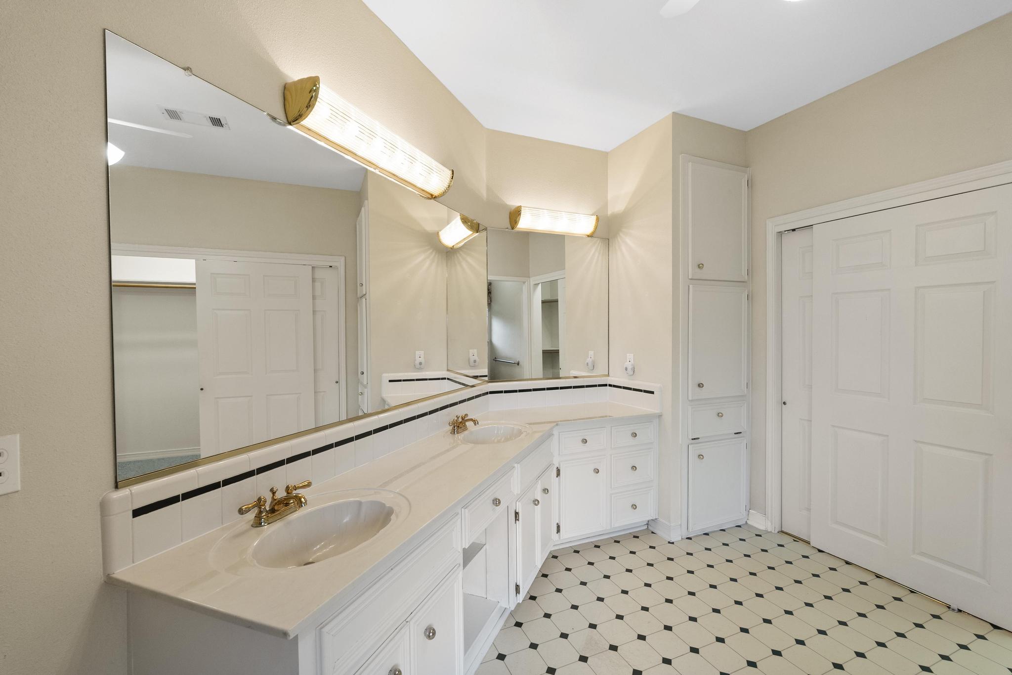 1906 Meadow Ridge Drive Taylor, TX 76574 - Photo 14 of 24 a bathroom with a sink a vanity and a mirror