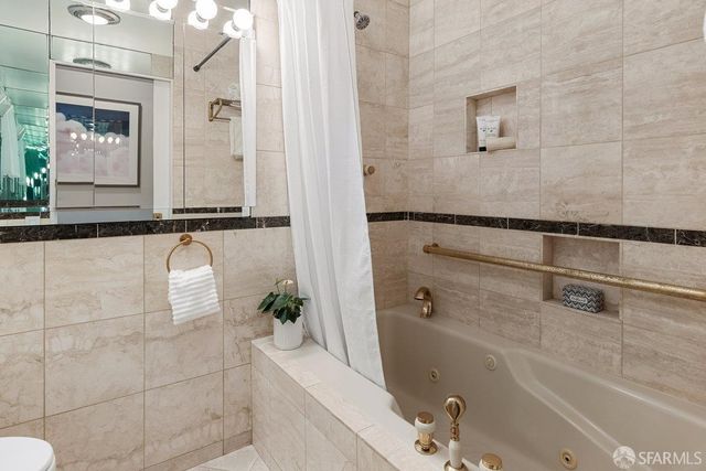 a bathroom with a bathtub and shower