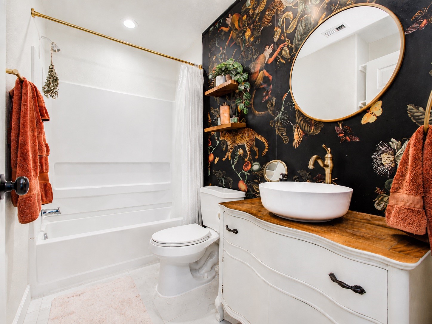 8647 Suburban Oaks Road Houston, TX 77093 - Photo 15 of 21 The secondary bath view centers the statement vanity wall, round mirror, and tub area. (photo has been enhanced for marketing purposes)