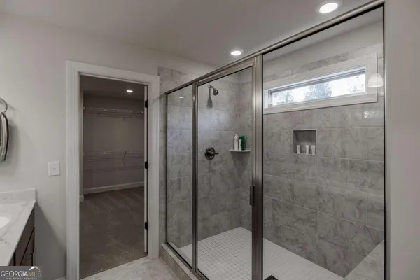 a view of a workspace with wooden floor and a window