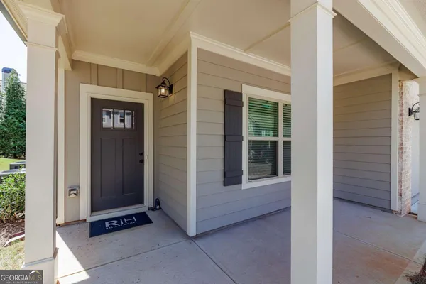 a view of a hallway with wooden floor and entryway