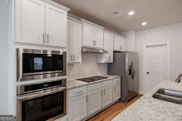 a living room with furniture and kitchen view