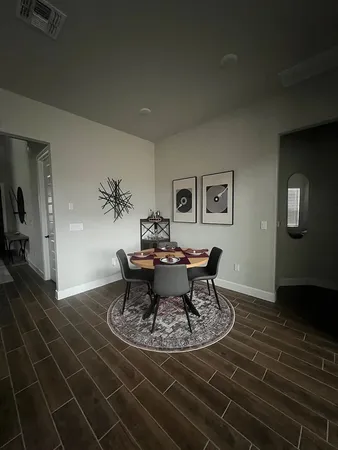 a view of a dining room with furniture and wooden floor
