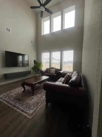 a living room with furniture and a flat screen tv