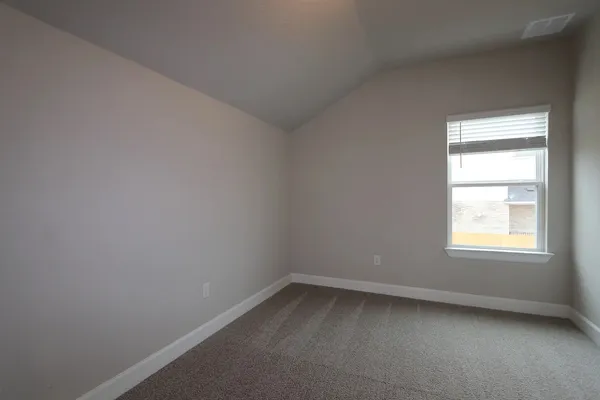 a view of a garden with a building in the background