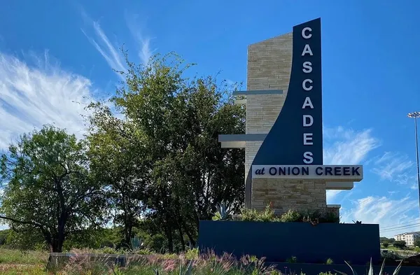 a view of a swimming pool and lounge chairs