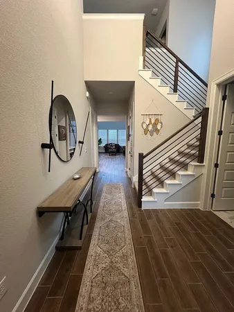 a view of a livingroom with furniture and staircase