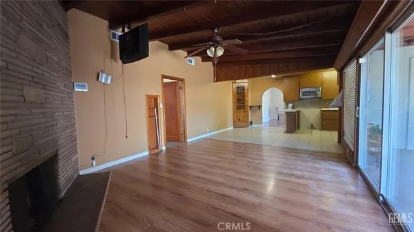 a view of a hallway with wooden floor and a fireplace