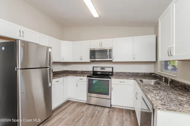 a kitchen with a refrigerator stove and microwave