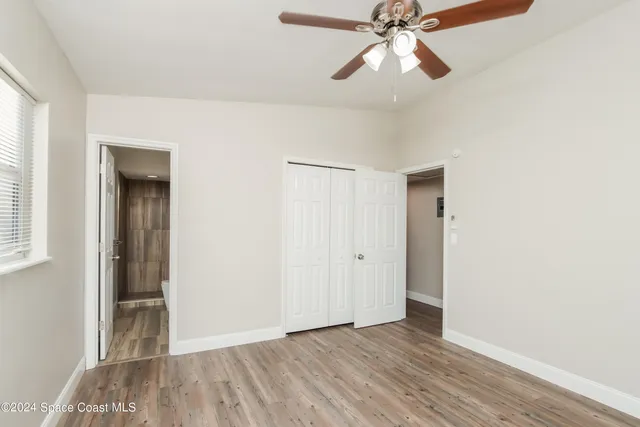 a view of room with hardwood floor and ceiling fan