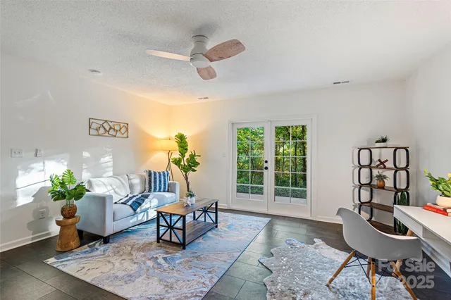a living room with furniture and a potted plant