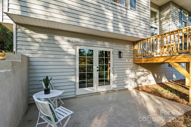 a view of a chair and tables in the balcony