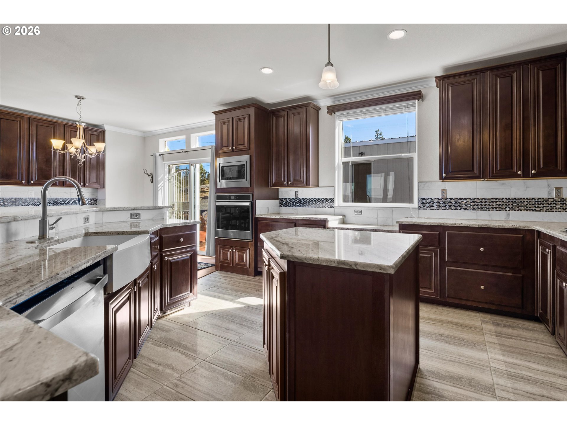 5172 Southeast Oswego Road Prineville, OR 97754 - Photo 11 of 48 a kitchen with kitchen island granite countertop a sink stove and cabinets