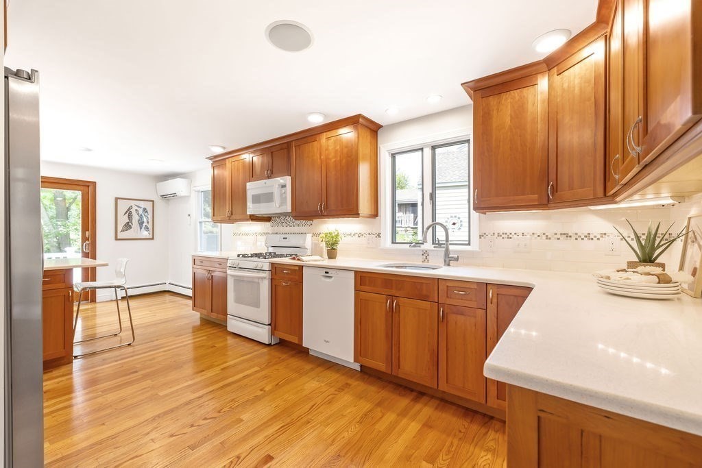 21 Vanderbelt Road Acton, MA 01720 - Photo 7 of 36 a kitchen with stainless steel appliances kitchen island granite countertop a sink and cabinets