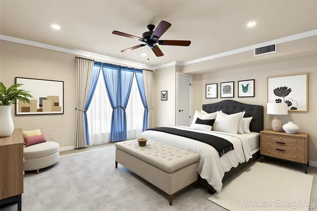 a spacious bedroom with a bed couch and a window