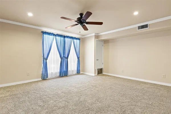 a view of empty room with ceiling fan