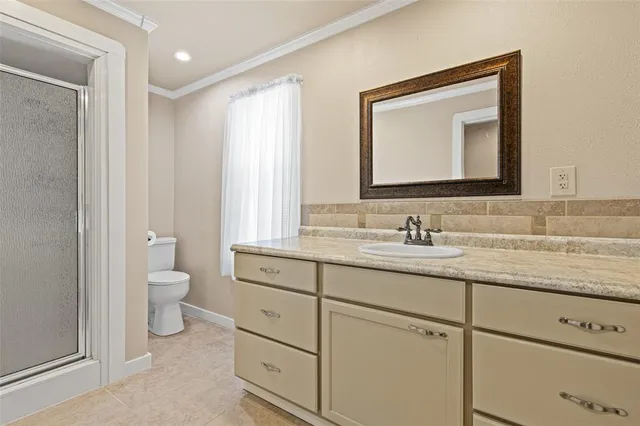 a bathroom with a granite countertop toilet sink and a mirror