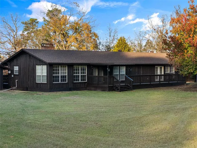 a view of a house with wooden floor roof and a small yard