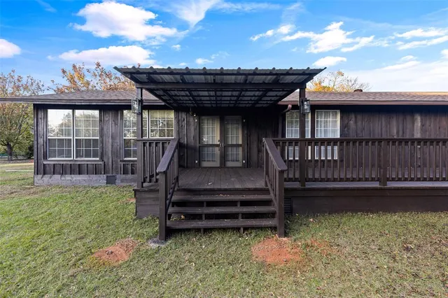a view of a house with a yard and sitting area