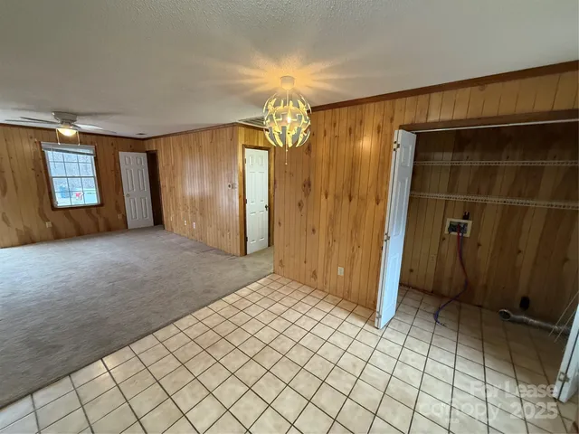 an empty room with closet and windows