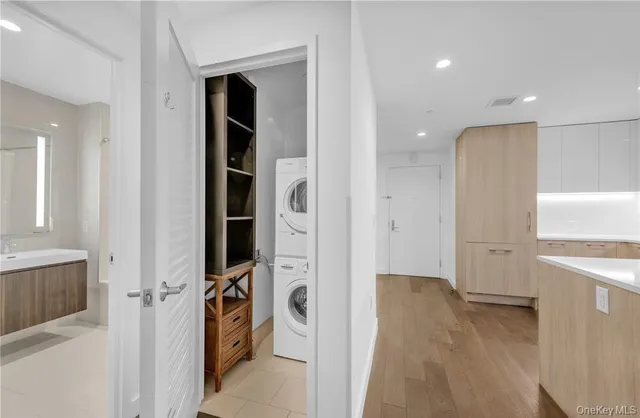a view of a hallway and closet with a fireplace