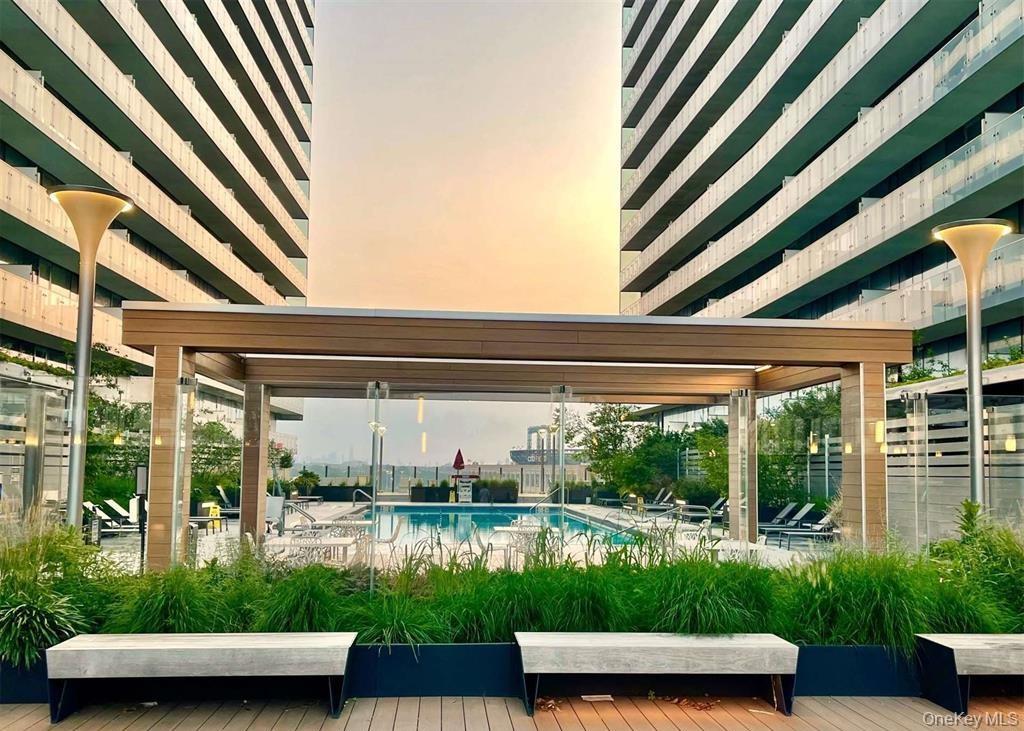 131-03 40 Road, Unit 16D Queens, NY 11354 - Photo 12 of 16 a view of patio with couches and pool