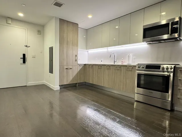 a kitchen with granite countertop stainless steel appliances and cabinets