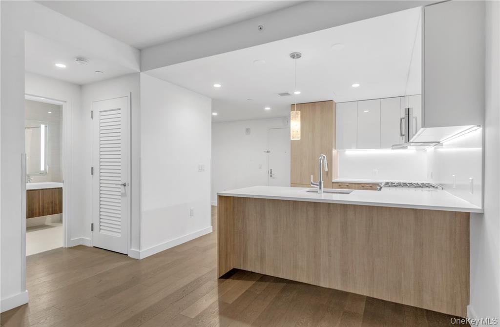 131-03 40 Road, Unit 16D Queens, NY 11354 - Photo 4 of 16 a view of kitchen with wooden floor