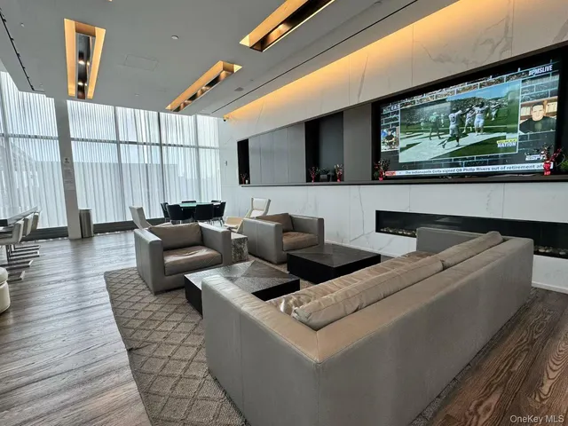 a living room with furniture and painting on the wall