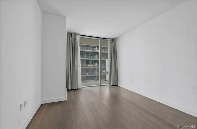 an empty room with wooden floor and empty shelves