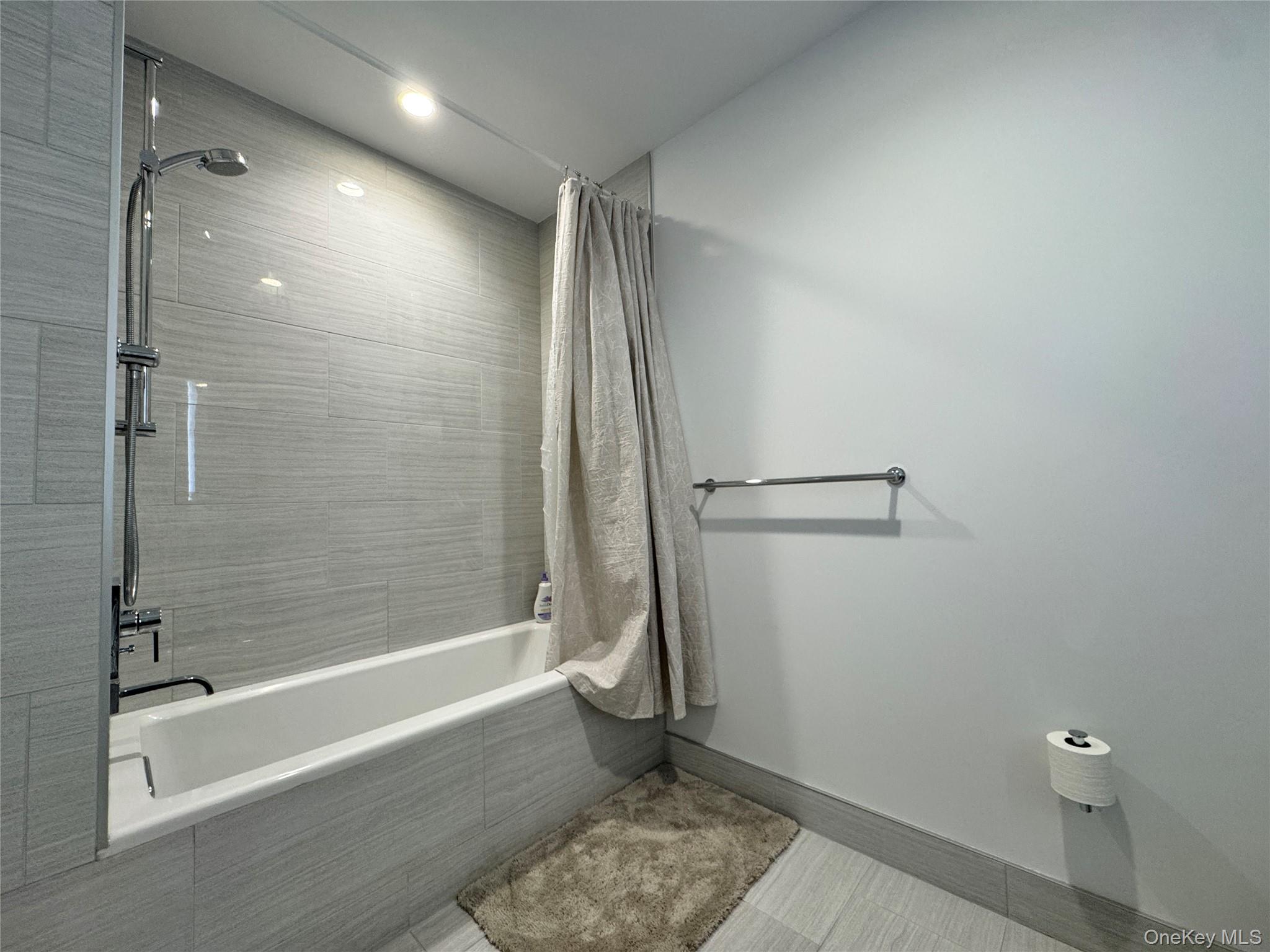 131-03 40 Road, Unit 16D Queens, NY 11354 - Photo 9 of 10 a bathroom with a shower and a toilet