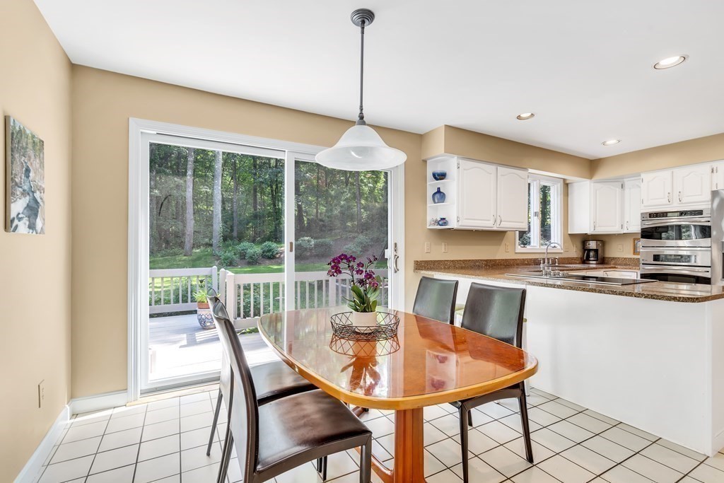 1031 Boston Post Road Sudbury, MA 01776 - Photo 13 of 36 a dining room with furniture a chandelier and wooden floor