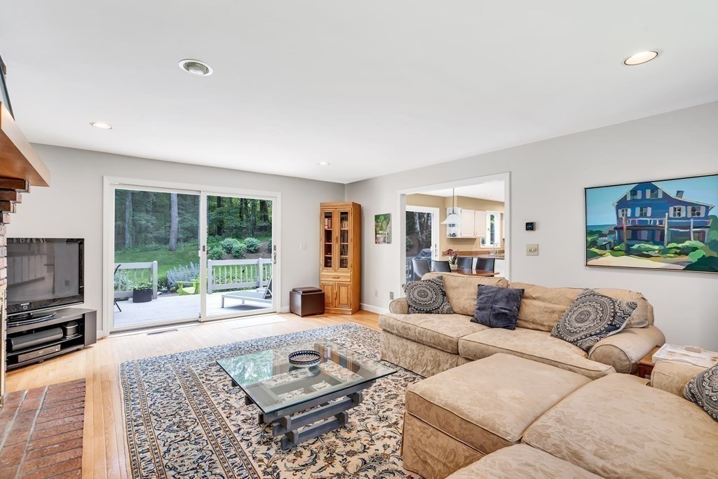 1031 Boston Post Road Sudbury, MA 01776 - Photo 17 of 36 a living room with furniture large window and a flat screen tv