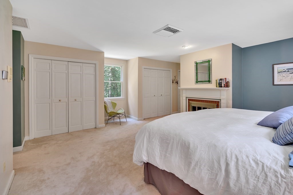 1031 Boston Post Road Sudbury, MA 01776 - Photo 28 of 36 a bedroom with a large bed and a chandelier