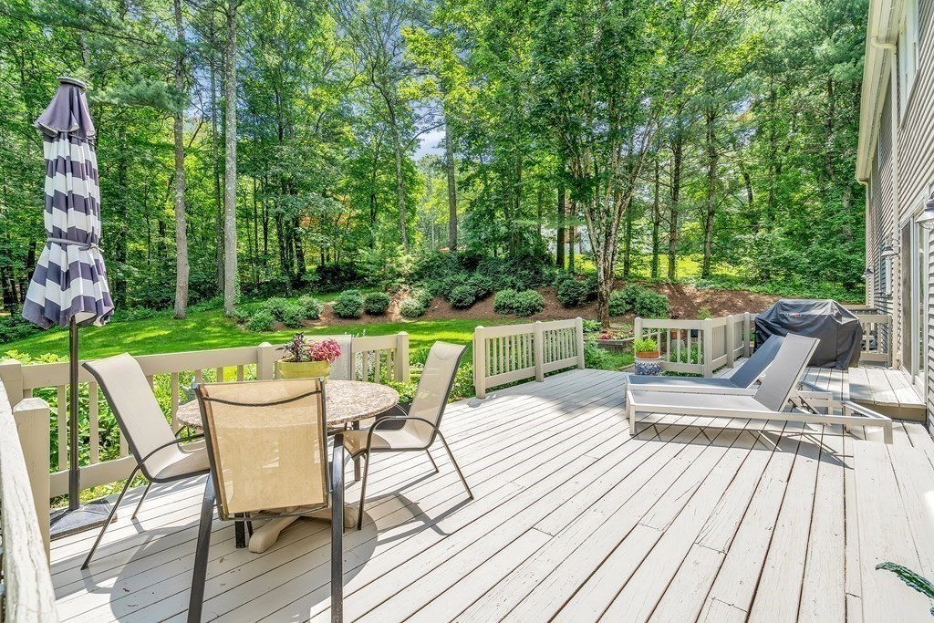 1031 Boston Post Road Sudbury, MA 01776 - Photo 3 of 36 a view of a chairs and table on the wooden deck
